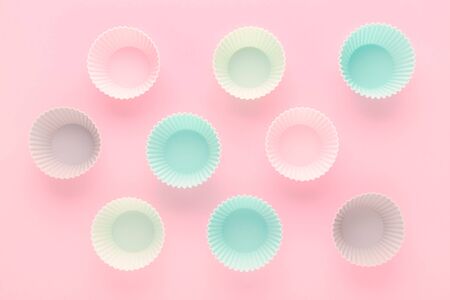 silikone forms for baking muffins and cupcakes on pastel pink backgroundの写真素材