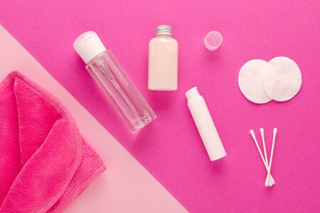 make up remove products, micellar water, face cleaning cloth, cleansing milk and gel with cotton pads on pink backgroundの写真素材