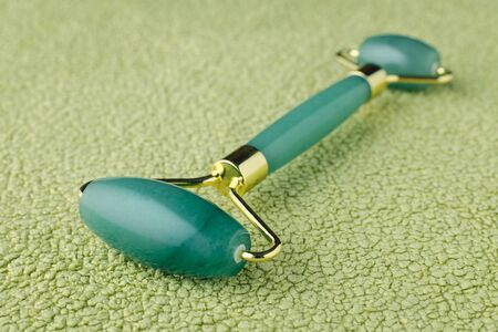 real jade stone facial roller, natural skin care tool, beauty device, selective focusの写真素材