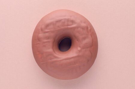 chocolate donut on brown background, flat layの写真素材