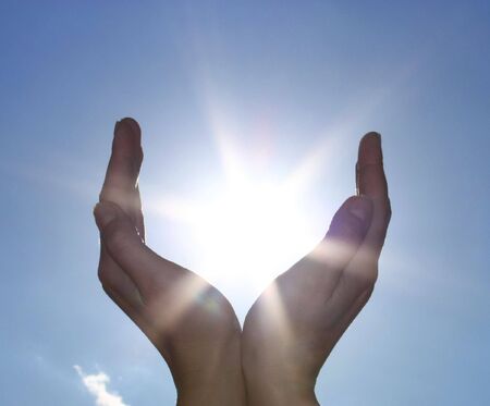 hands take the power of sunの写真素材