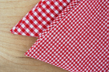 checkered napkins on wooden table