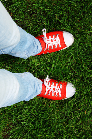 Woman in red sneakers on green grassの写真素材