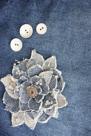 handmade denim flower on blue denim backgroundの写真素材