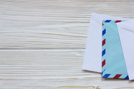 three envelopes on wooden backの写真素材