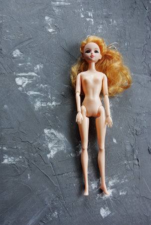plastic doll on grey backgroundの写真素材