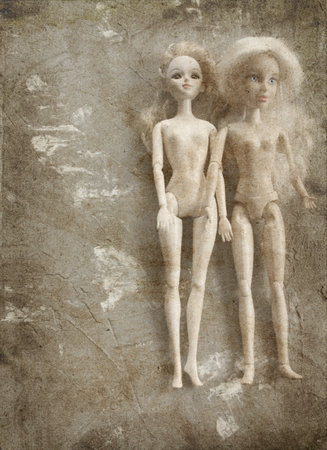 two  old plastic dolls. image in vintage grunge styleの写真素材