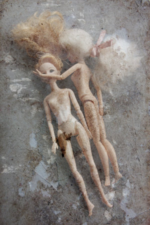 two  old plastic dolls. image in vintage grunge styleの写真素材