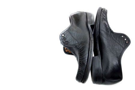 old black leather shoes isolated on whiteの写真素材