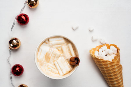 a cup of hot coffee on the table. Homemade waffles with marshmallows and cinnamon. Cozy atmosphere. New year's and christmasの写真素材