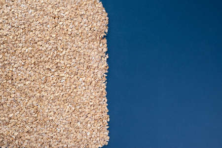 oatmeal sprinkled on half a sheet, with space for textの写真素材