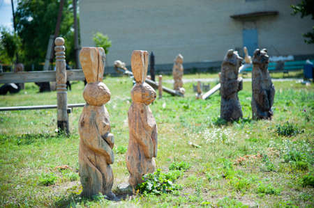 hares carved from wood on a summer playgroundの写真素材