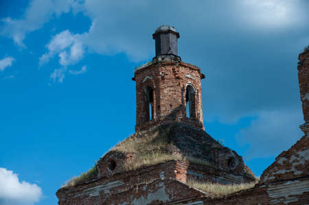 the roof of the old church is overgrown with grass