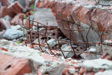 metal wire among destroyed bricksの写真素材