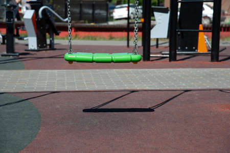 empty swing without back in the playground
