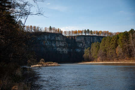 autumn landscape of the river on the background of rocks
