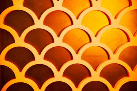 Magical texture of fish scales in gold and orange tones close-up. Fish scales seamless pattern. Yellow textured background.の写真素材