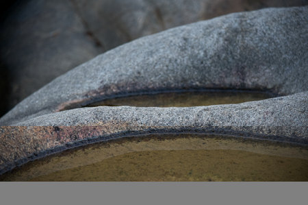 Large stones with indentations close-up with water, wallpaperの写真素材
