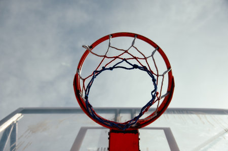 Basketball hoop and net against cloudy sky background. Close up.の写真素材