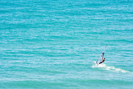A person alone doing windsurf in the seaの写真素材