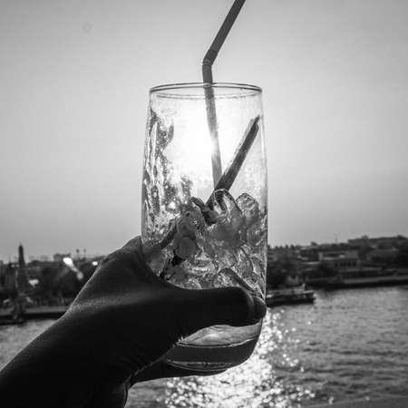 Glass of Water and sunset background, outdoorsの写真素材