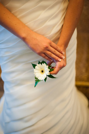 bride holding a white gerbera