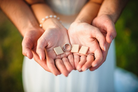 man and woman holding wooden letters in their handsの写真素材