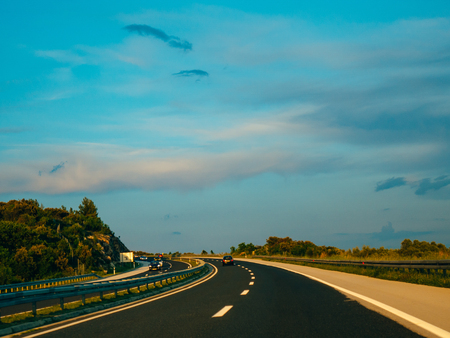 The road at sunset. Motorway in Croatia. View of the car. The mountains and the horizon line at the backgroundの写真素材