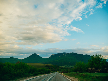 The road through the mountains. Cloudy day at sunset.の写真素材