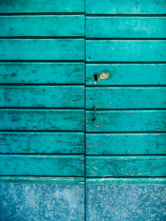 Old blue doors. Wood texture. Texture of metal. Old shabby, irradiated paintの写真素材