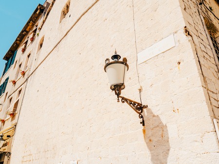 Vintage lamp on the wall on the street.の写真素材
