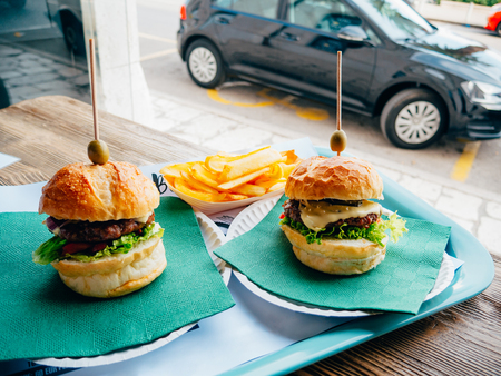 Two hamburger on a tray in a cafe. Burger Cafe in Split, on the waterfront, Croatia.の写真素材