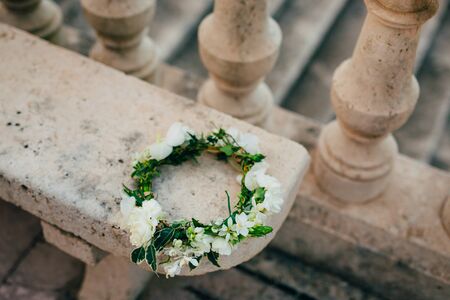 Wreath Bride of white flowers on old stone bench.の写真素材