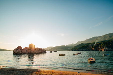 Przno, Montenegro. Beach, sun beds and umbrellas on the beach, the beach line.の写真素材