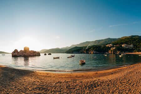 Przno, Montenegro. Beach, sun beds and umbrellas on the beach, the beach line.の写真素材
