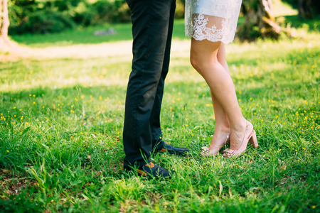 The bride and groom in the forest. Feet of the newlyweds on the grass. Wedding in Montenegro.の写真素材
