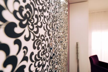 Black and White wallpaper with an ornament on the wallの写真素材