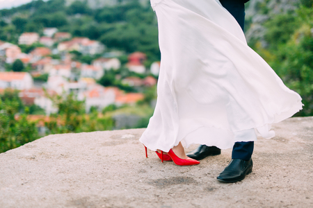 Legs is newlywed on the stone floor. Wedding in Montenegro.の写真素材