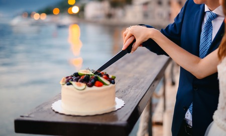 Wedding tradition - the cutting of the wedding cake bride and groom.の写真素材