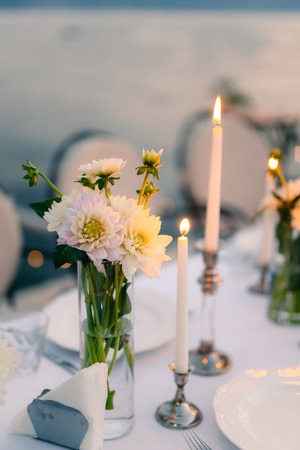 White asters on the table in the restaurant. Wedding decorations. Wedding in Montenegro.の写真素材