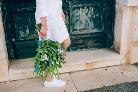 Wedding bridal bouquet of roses, lisianthus, lavender, Gypsophila, Verdure Italian in the hands of the bride. Wedding in Croatia, Dubrovnik.の写真素材