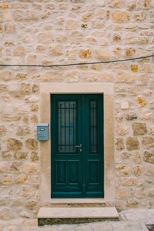 Green doors. Wood texture. Old shabby, irradiated paint. Old wooden doorsの写真素材