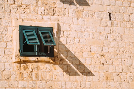 Green window shutters. The facade of houses in Montenegro.の写真素材