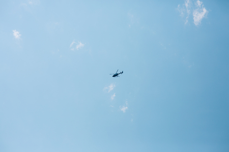 Tourist helicopter in the sky. Blue sky and clouds.
