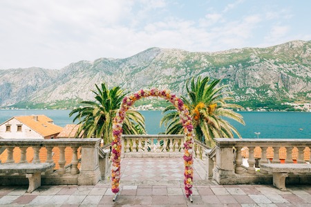 Wedding Arch of hydrangeas and roses. Wedding ceremony in the Bay of Kotor, in Montenegro, in the territory of the church of the Nativity of the Virgin in Prcanjの写真素材
