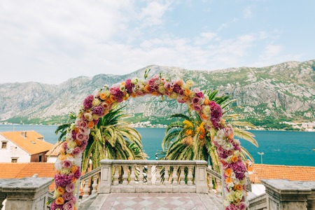 Wedding Arch of hydrangeas and roses. Wedding ceremony in the Bay of Kotor, in Montenegro, in the territory of the church of the Nativity of the Virgin in Prcanjの写真素材