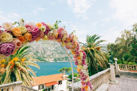 Wedding Arch of hydrangeas and roses. Wedding ceremony in the Bay of Kotor, in Montenegro, in the territory of the church of the Nativity of the Virgin in Prcanjの写真素材
