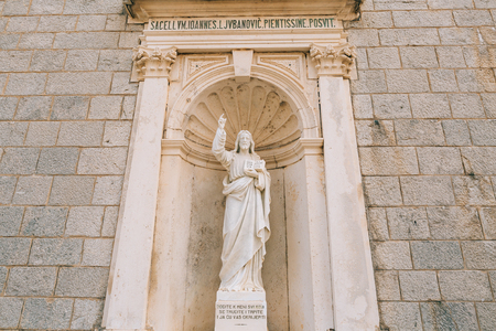 Ancient statue on the territory of the Church of the Nativity of Our Lady in Prcanj, Montenegroの写真素材