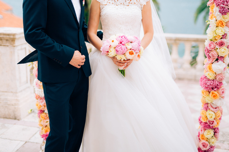 The groom embraces the bride on the beach. Wedding in Montenegro and Croatia.の写真素材