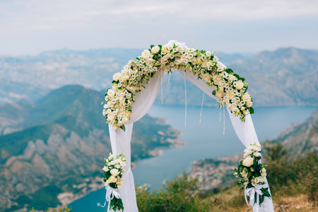 A wedding in the mountains. Wedding arch for the ceremony on the summit of Mount Lovcen in Montenegroの写真素材